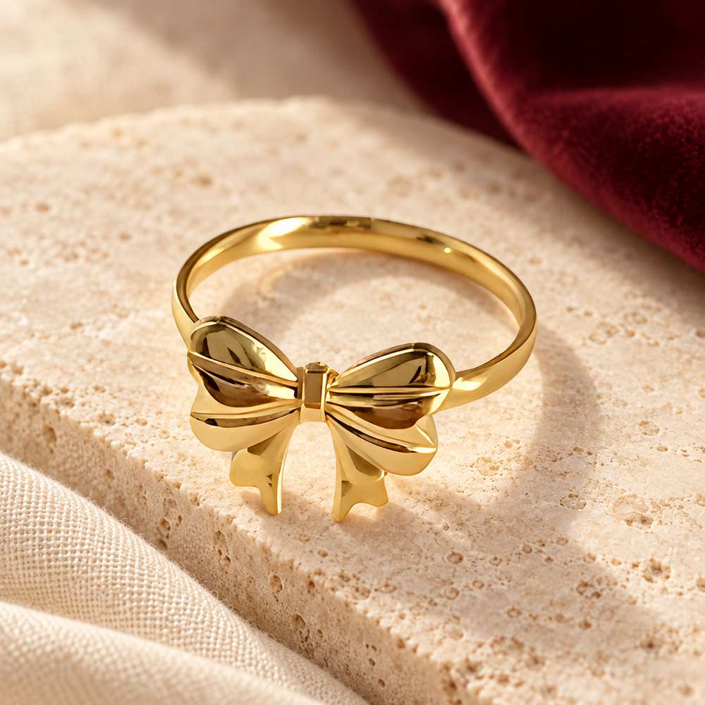 Gold-tone bow ring on ivory stone