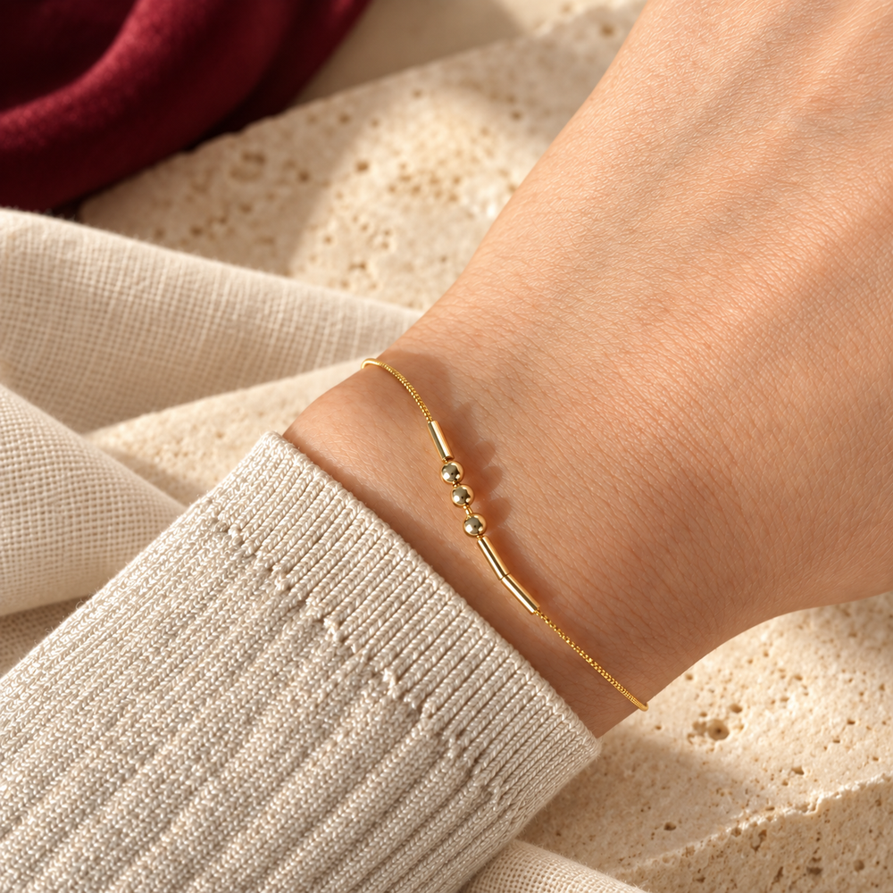 Styled Morse Code bracelet illustration on a wrist against ivory linen